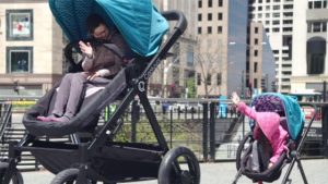 Adults test-ride the baby stroller for adults by Contour.